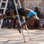 image of dancer laying across ladder
